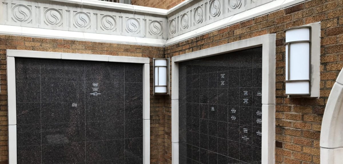 Decorative lights embedded in the brick masonry of the columbarium structure lie between each cabinet.